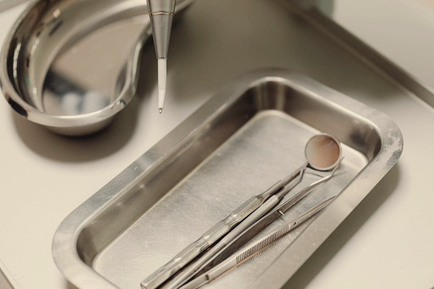 Sterilised dental instruments laid out on a steel tray.